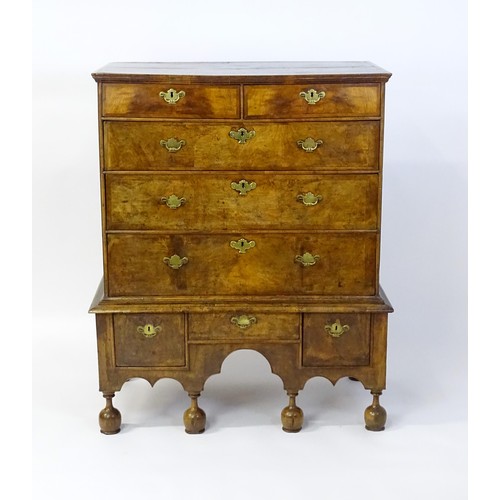 1463 - An early 18thC walnut veneered chest on stand, the moulded top above two short over three long gradu... 