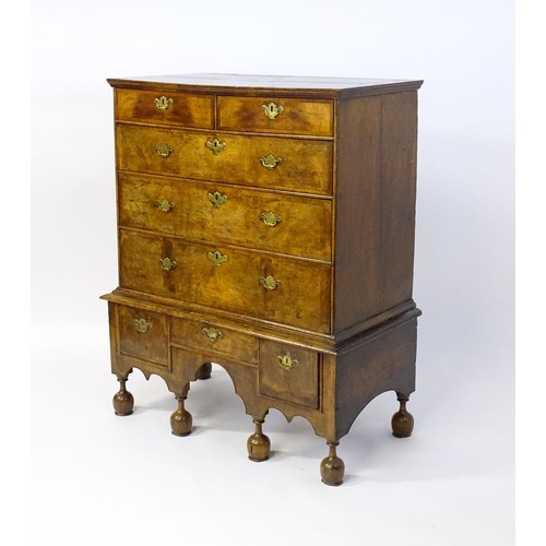 1463 - An early 18thC walnut veneered chest on stand, the moulded top above two short over three long gradu... 