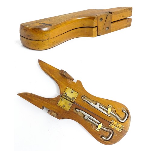 1192 - An early 20thC folding boot jack opening to reveal a pair of steel boot / button hook tools. Approx.... 