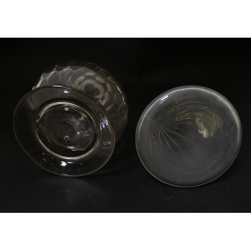 270A - Two items of glassware to include a 19thC facet cut glass bottle of globular form with screw top and... 
