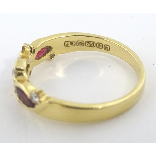 618 - An 18ct gold ring set with three rubies and six diamonds. Ring size approx. P 1/2