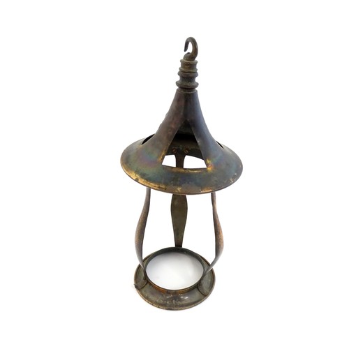 1055 - An Arts & Crafts copper pendant light frame of lantern form, the copper supports with hammered decor... 