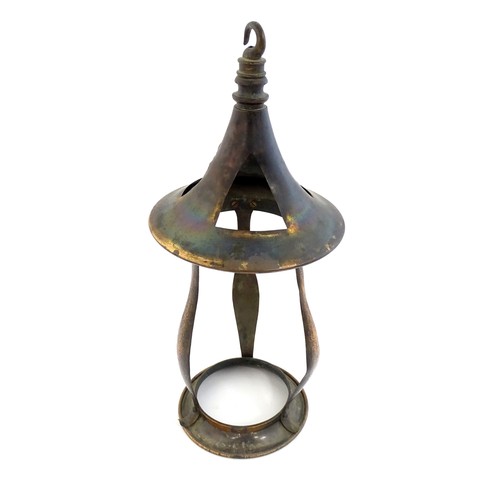 1055 - An Arts & Crafts copper pendant light frame of lantern form, the copper supports with hammered decor... 