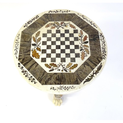 1441 - A marble games table / occasional table with a circular top and inlaid marble decoration. The top ha... 