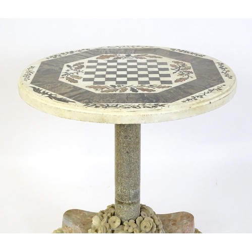 1441 - A marble games table / occasional table with a circular top and inlaid marble decoration. The top ha... 