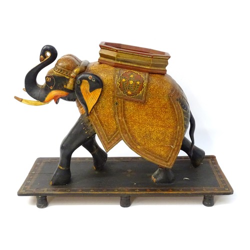 1304 - Two large Kashmir wooden models of elephants with polychrome decoration raised on rectangular bases.... 