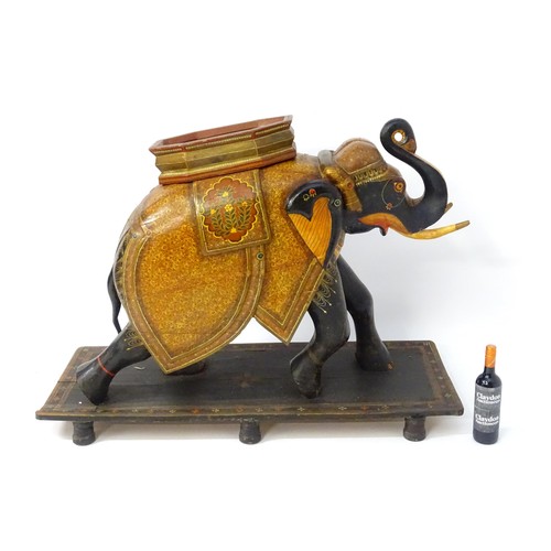 1304 - Two large Kashmir wooden models of elephants with polychrome decoration raised on rectangular bases.... 