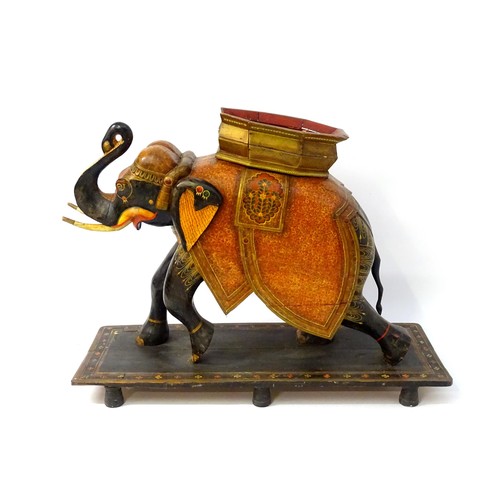 1304 - Two large Kashmir wooden models of elephants with polychrome decoration raised on rectangular bases.... 