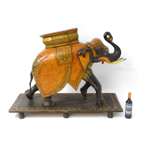 1304 - Two large Kashmir wooden models of elephants with polychrome decoration raised on rectangular bases.... 