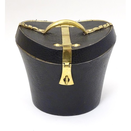 85 - A 21stC novelty brass caddy / container formed as a saddle shaped hat box with black leather coverin... 