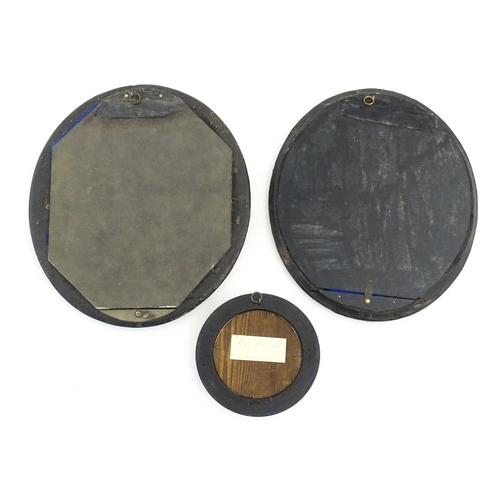 90 - A pair of early 20thC ebonised frames of oval form. Together with a ebonised frame of circular form.... 