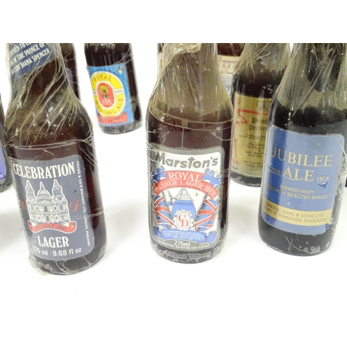 212 - A quantity of late 20thC commemorative bottles of beer / ale / bitter / lager , including brews by E... 