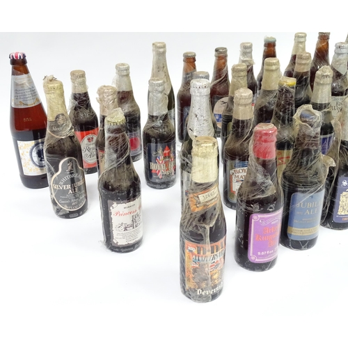 212 - A quantity of late 20thC commemorative bottles of beer / ale / bitter / lager , including brews by E... 