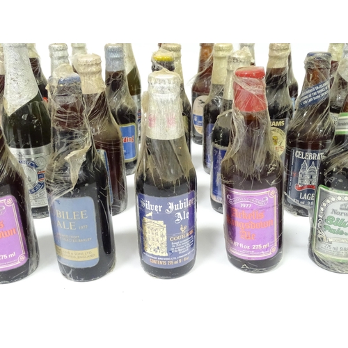 212 - A quantity of late 20thC commemorative bottles of beer / ale / bitter / lager , including brews by E... 