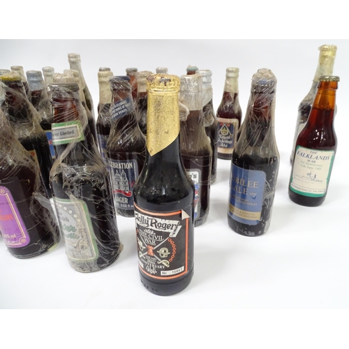 212 - A quantity of late 20thC commemorative bottles of beer / ale / bitter / lager , including brews by E... 