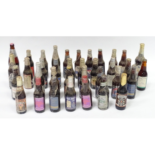 212 - A quantity of late 20thC commemorative bottles of beer / ale / bitter / lager , including brews by E... 