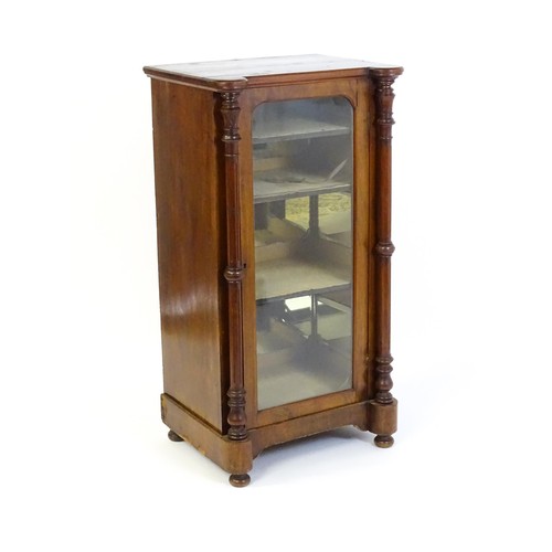 215 - A late 19thC / early 20thC music cabinet of larger proportions, having a castellated front edge, two... 