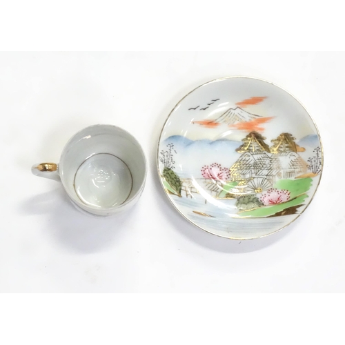 243 - A quantity of Oriental coffee / dinner wares decorated with a watermill in a landscape, to include s... 