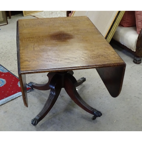 247 - A Regency drop flap mahogany table, with drop flaps to either side, a turned pedestal and four reede... 