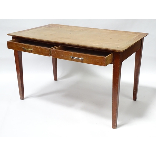 261 - A early 20thC office desk with four tapering legs. Produced by Cooke's of Finsbury. 48