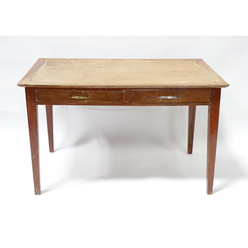 261 - A early 20thC office desk with four tapering legs. Produced by Cooke's of Finsbury. 48