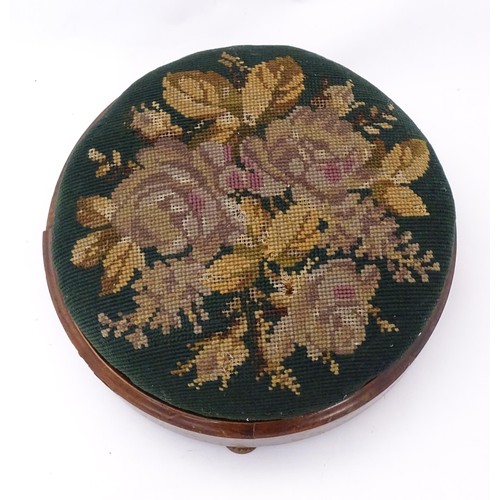 273 - A 19thC circular needlework footstool with an inset upholstered seat and a walnut frame raised on sq... 