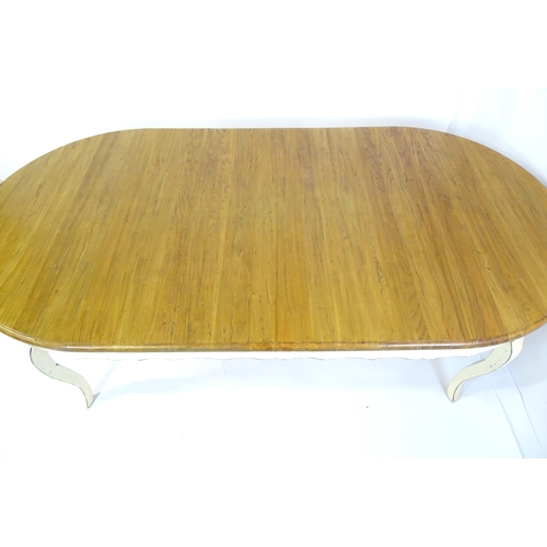 305 - A late 20thC dining table together with a set of eight dining chairs. The table having an oak top ab... 