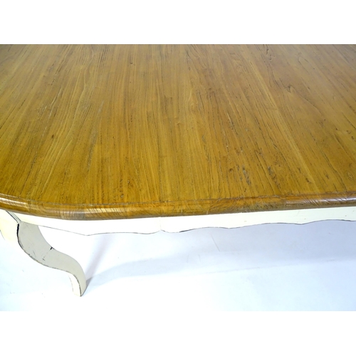 305 - A late 20thC dining table together with a set of eight dining chairs. The table having an oak top ab... 