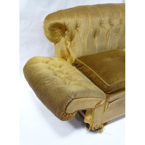 343 - A Victorian two seater button back sofa, with drop-end mechanism to each arm. Measuring approx 68