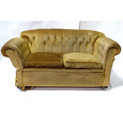 343 - A Victorian two seater button back sofa, with drop-end mechanism to each arm. Measuring approx 68