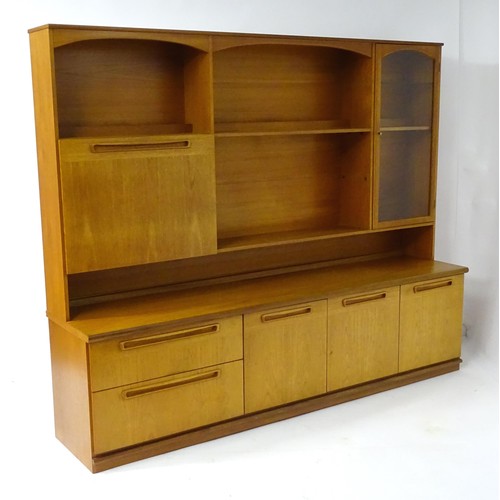 355 - Vintage / Retro: A teak sideboard by Meredew, having fitted storage shelves within alcoves,  a glaze... 