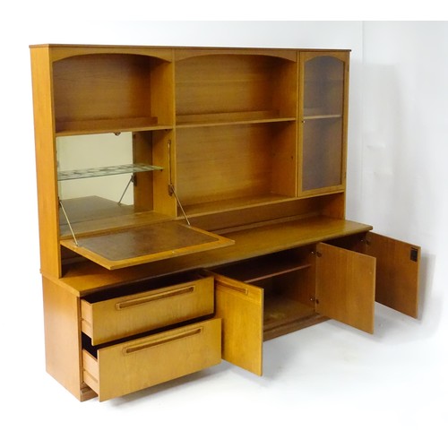 355 - Vintage / Retro: A teak sideboard by Meredew, having fitted storage shelves within alcoves,  a glaze... 