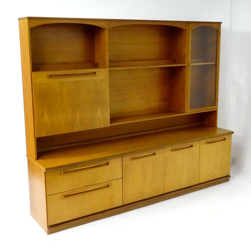 355 - Vintage / Retro: A teak sideboard by Meredew, having fitted storage shelves within alcoves,  a glaze... 