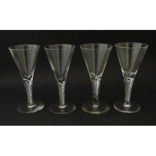 365 - Four late 20thC drinking gasses with air twist detail to stems . Tallest approx. 5 3/4