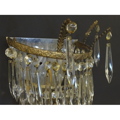 401 - A pair of three tier wall lights with lustre drops and floral and foliate gilt metal detail. Approx.... 