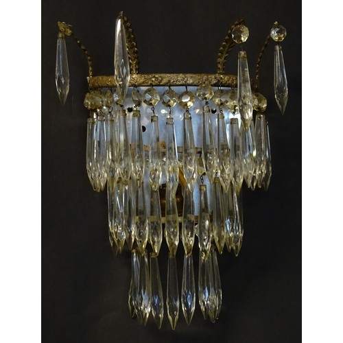 401 - A pair of three tier wall lights with lustre drops and floral and foliate gilt metal detail. Approx.... 