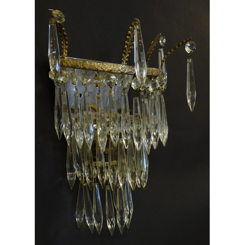 401 - A pair of three tier wall lights with lustre drops and floral and foliate gilt metal detail. Approx.... 