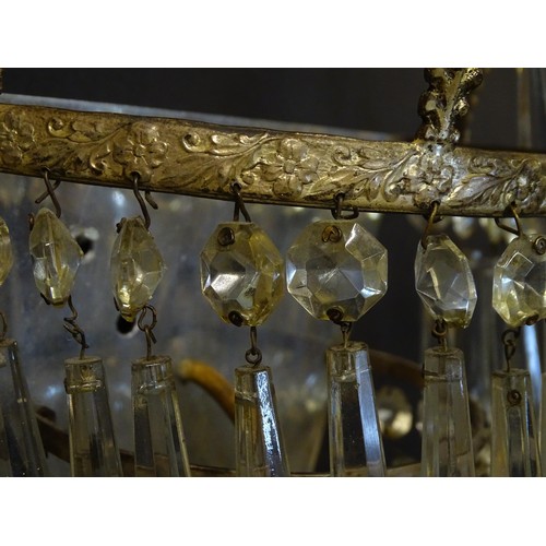 401 - A pair of three tier wall lights with lustre drops and floral and foliate gilt metal detail. Approx.... 