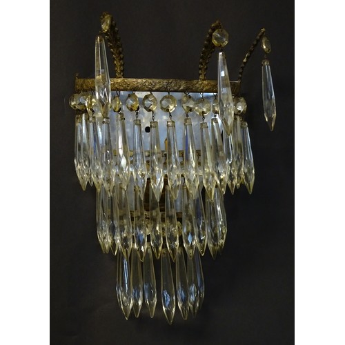 401 - A pair of three tier wall lights with lustre drops and floral and foliate gilt metal detail. Approx.... 