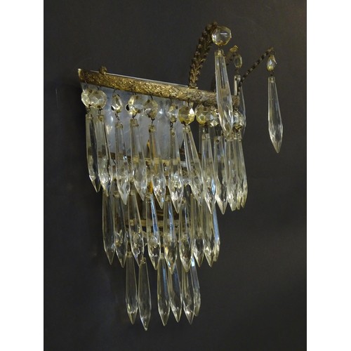 401 - A pair of three tier wall lights with lustre drops and floral and foliate gilt metal detail. Approx.... 