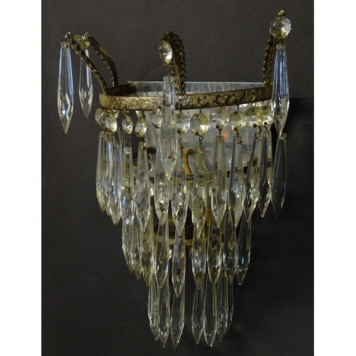 401 - A pair of three tier wall lights with lustre drops and floral and foliate gilt metal detail. Approx.... 