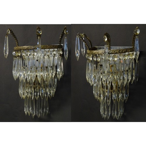 401 - A pair of three tier wall lights with lustre drops and floral and foliate gilt metal detail. Approx.... 