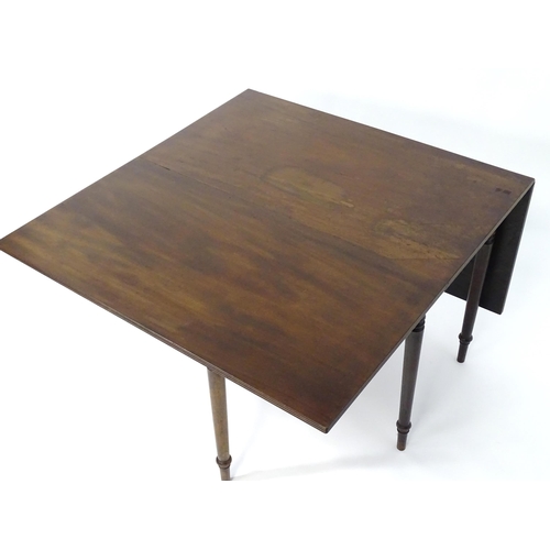 403 - A Regency period mahogany drop flap table with a reeded top edge above six turned tapering legs term... 