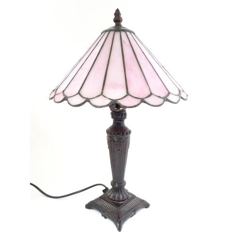 407 - A Tiffany style table lamp with pink leaded glass shade. the whole approx 17