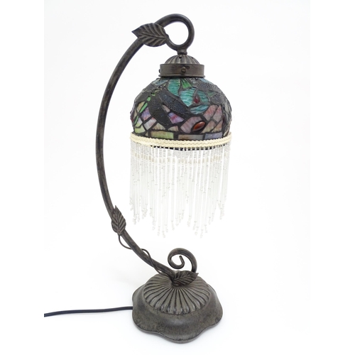 412 - A Tiffany style table lamp with dragon fly detail to shade. The whole approx 19