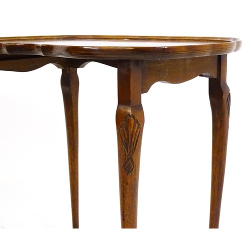 437 - Two burr walnut veneered tables, one a side  table raised on four shell carved legs with a shaped to... 