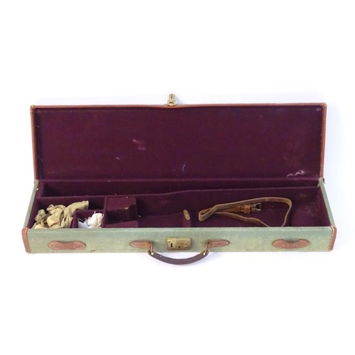 440 - A vintage canvas, leather and brass mounted motor case, with maroon baize lining, provision for 28 1... 