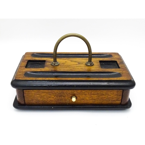 449 - An oak desk standish / ink stand  with central loop handle. Approx. 6 1/2