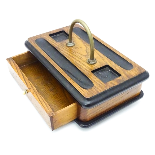 449 - An oak desk standish / ink stand  with central loop handle. Approx. 6 1/2