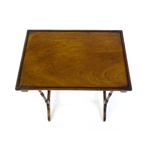 472 - A 19thC mahogany side table with turned tapering supports above shaped feet. 20